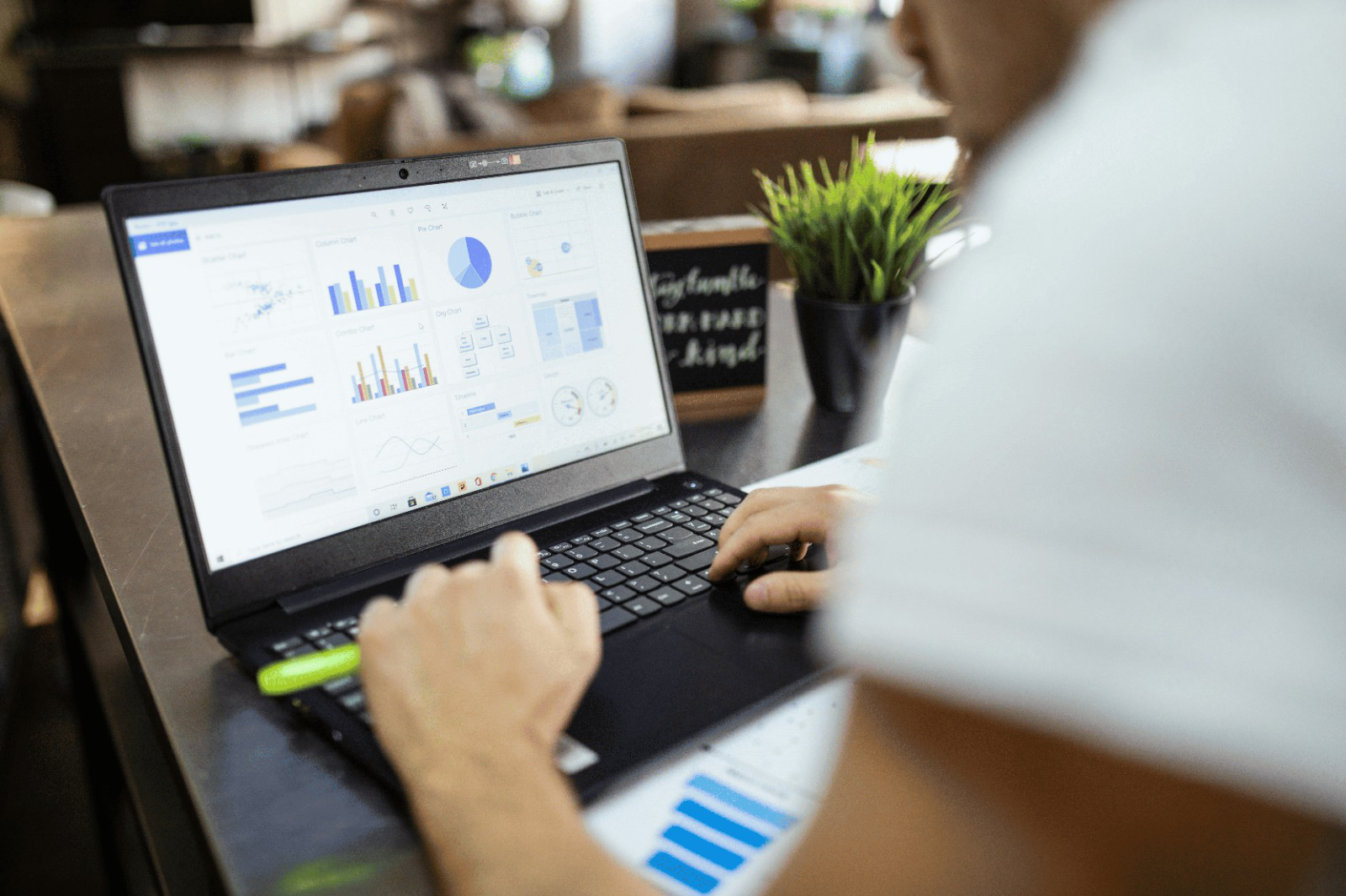 A person analyzing financial charts on a screen
